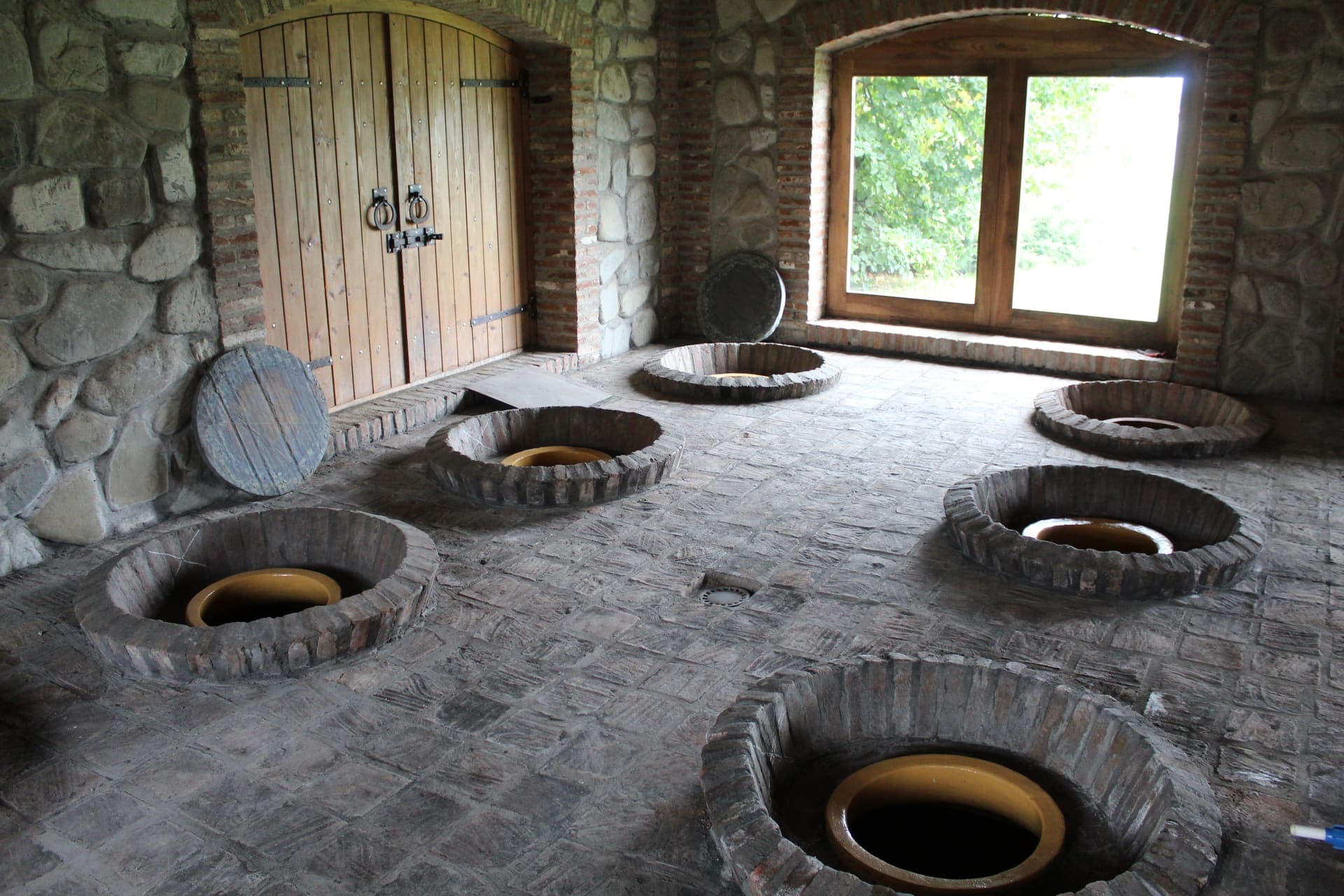 Inside a Georgian marani, where qvevri are buried to their mouths in the cellar floor